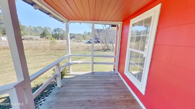 unfurnished sunroom with wood ceiling