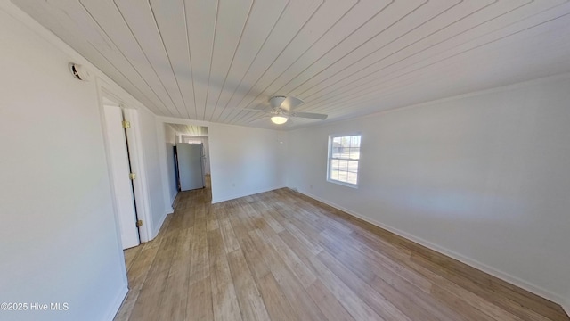 spare room with ceiling fan, wooden ceiling, and light wood-type flooring