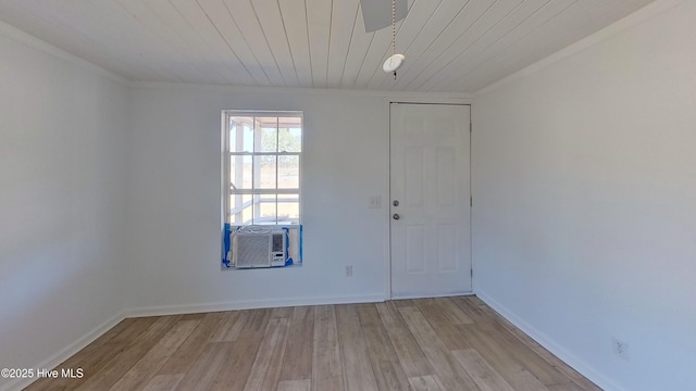 unfurnished room featuring cooling unit, wooden ceiling, and light wood-type flooring