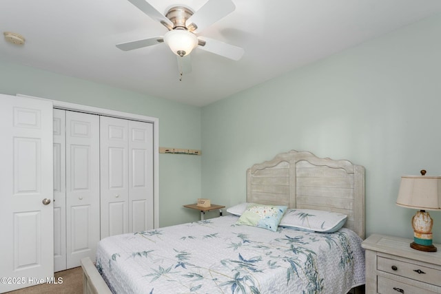 carpeted bedroom featuring ceiling fan and a closet