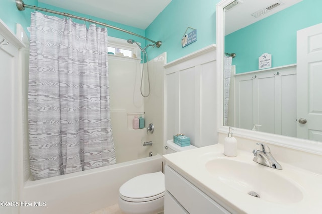 full bathroom featuring vanity, shower / bathtub combination with curtain, and toilet