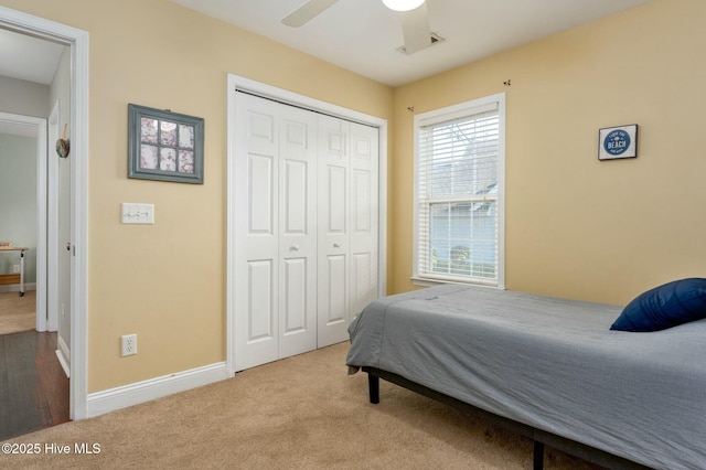 bedroom with carpet floors, a closet, and ceiling fan