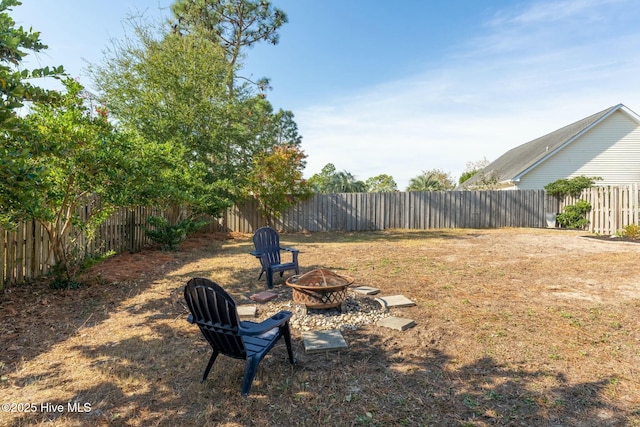 view of yard with a fire pit