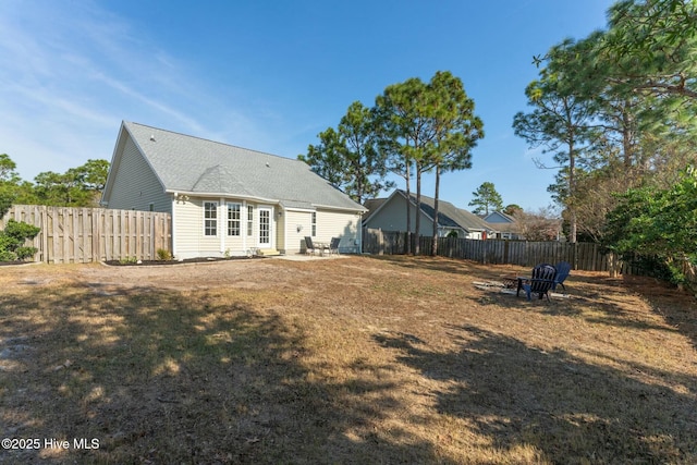 rear view of property with a patio and a yard