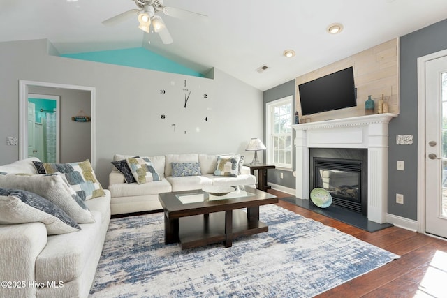 living room with lofted ceiling, dark wood-type flooring, and ceiling fan