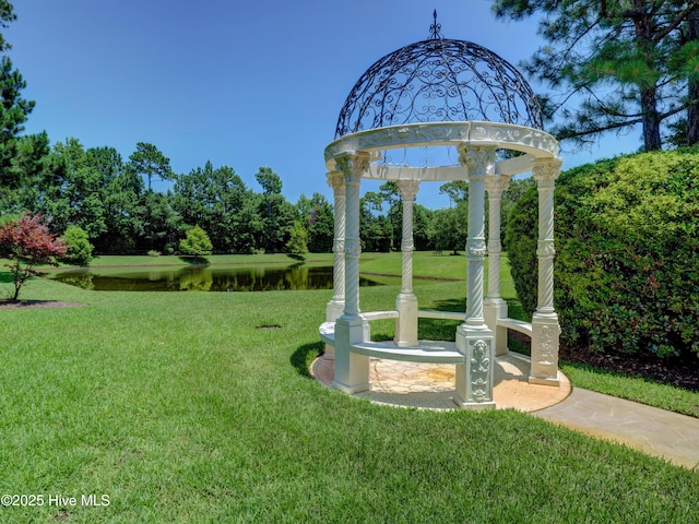 view of community with a gazebo, a water view, and a yard