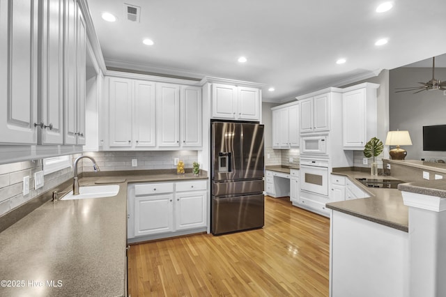 kitchen featuring crown molding, sink, white cabinets, and white appliances