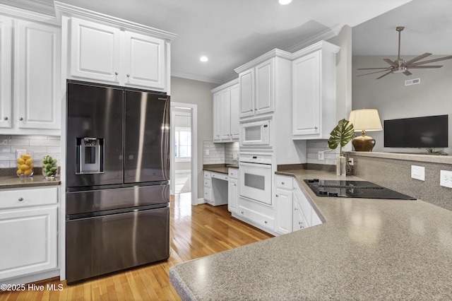 kitchen with ornamental molding, light wood-type flooring, white cabinets, and white appliances