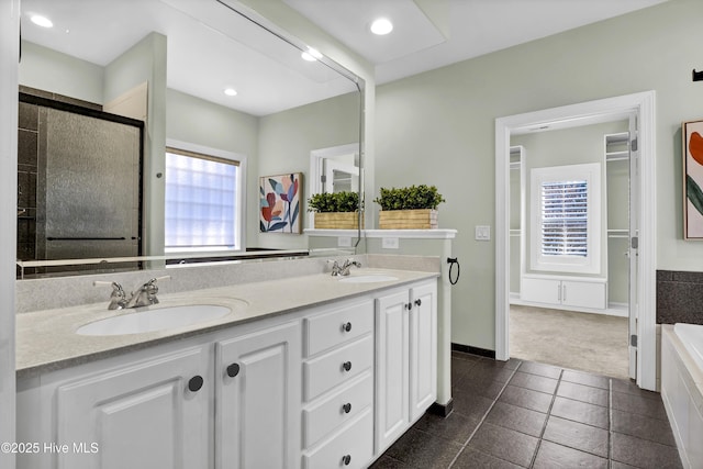 bathroom featuring vanity, independent shower and bath, and tile patterned flooring