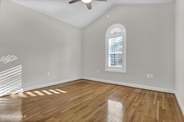 empty room with hardwood / wood-style flooring, lofted ceiling, and ceiling fan