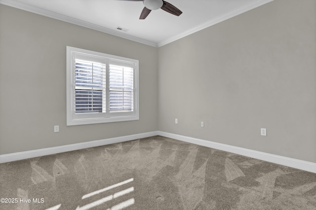 carpeted spare room featuring crown molding and ceiling fan