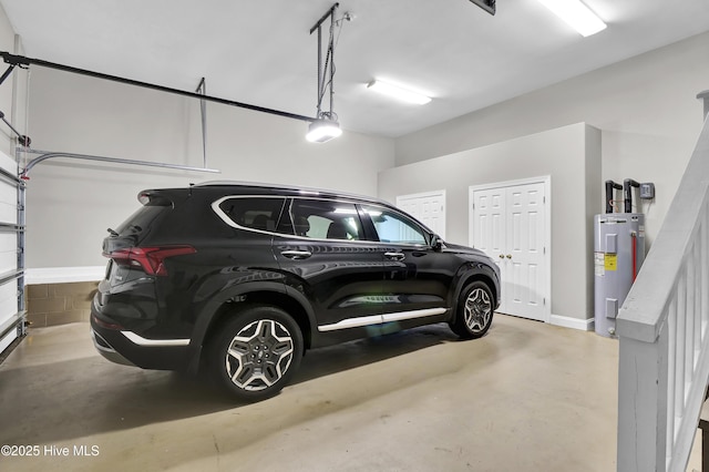 garage with a garage door opener and electric water heater