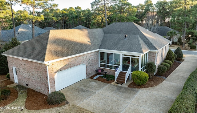 view of front of house with a garage and a sunroom