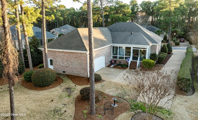 exterior space featuring a garage and a sunroom