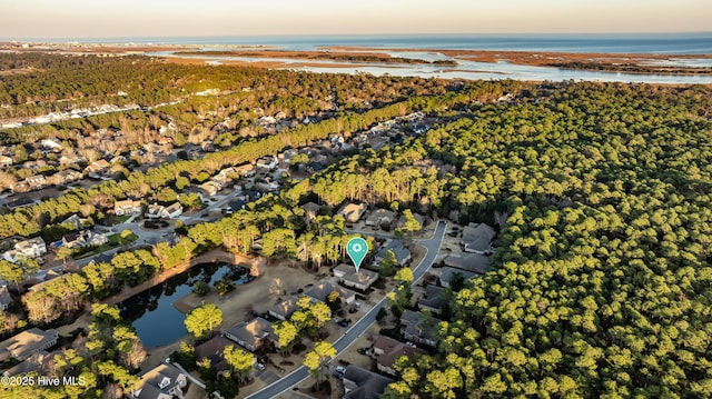 aerial view at dusk featuring a water view