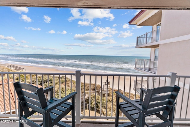 balcony with a view of the beach and a water view