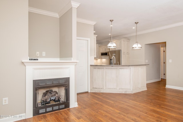 interior space with wood-type flooring and ornamental molding