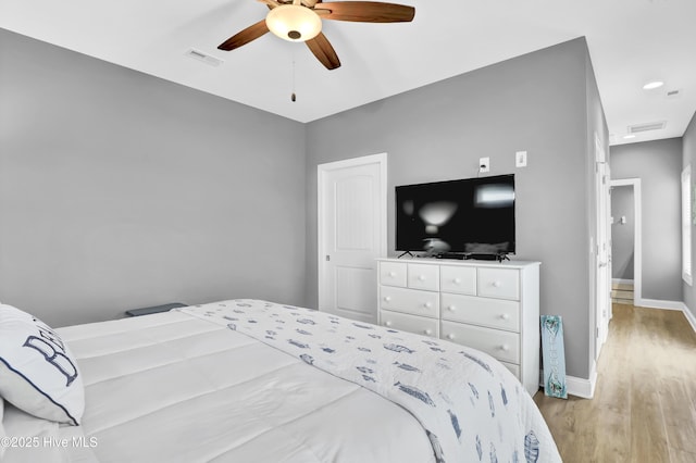 bedroom with ceiling fan and light hardwood / wood-style flooring