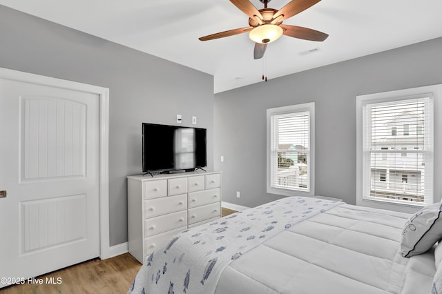 bedroom featuring light hardwood / wood-style flooring and ceiling fan