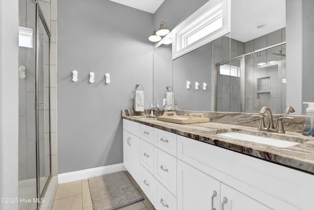 bathroom with vanity, an enclosed shower, and tile patterned floors