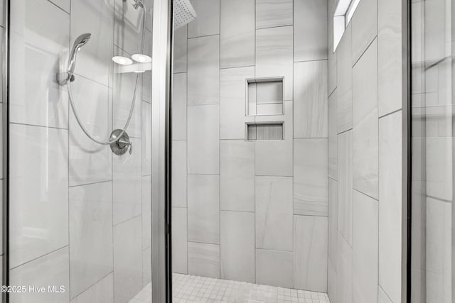 bathroom with a shower with door