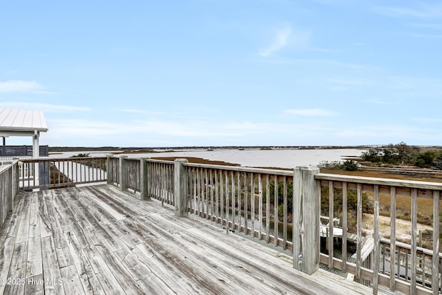 wooden deck featuring a water view