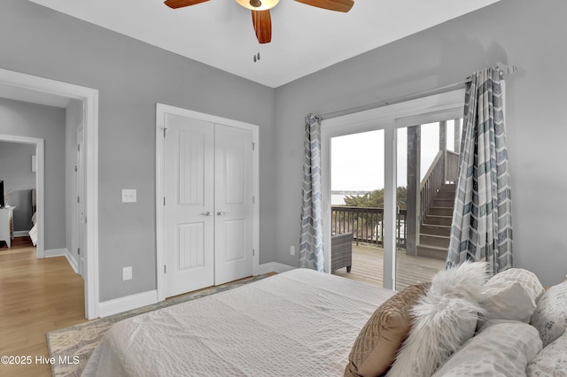 bedroom featuring access to outside, light hardwood / wood-style floors, a closet, and ceiling fan