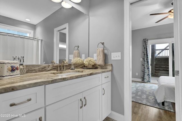 bathroom with vanity, hardwood / wood-style flooring, and ceiling fan