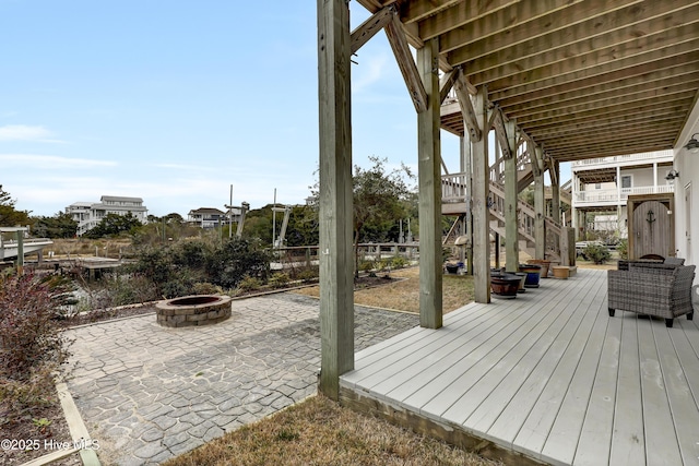 exterior space featuring a deck and an outdoor fire pit