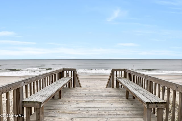 view of home's community with a beach view and a water view