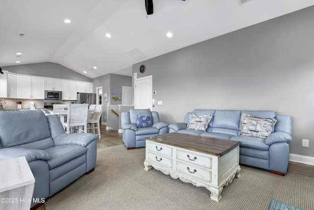 living room featuring ceiling fan and vaulted ceiling