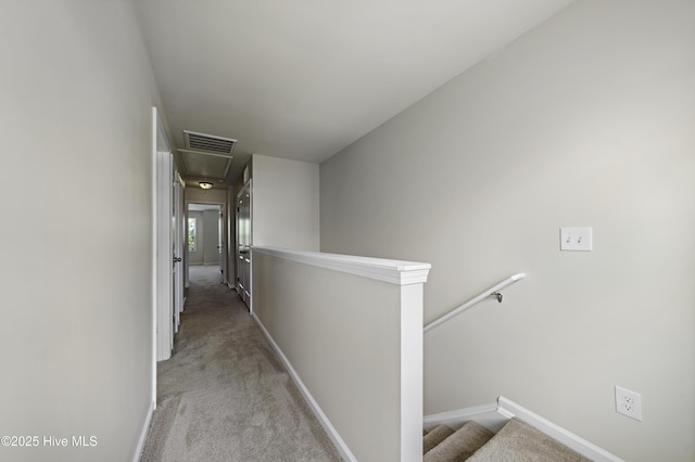 hallway featuring light colored carpet