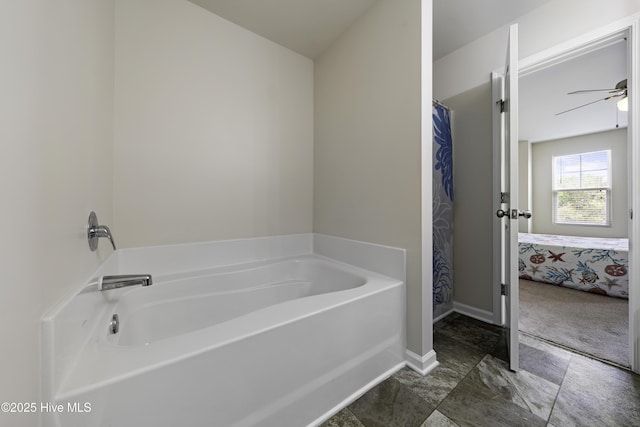 bathroom with a washtub and ceiling fan