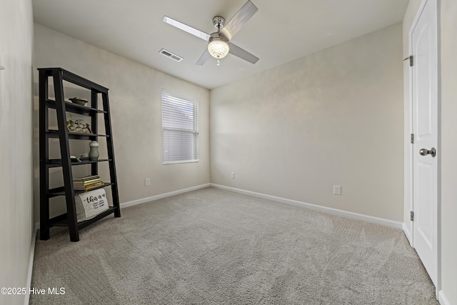 empty room with light colored carpet and ceiling fan