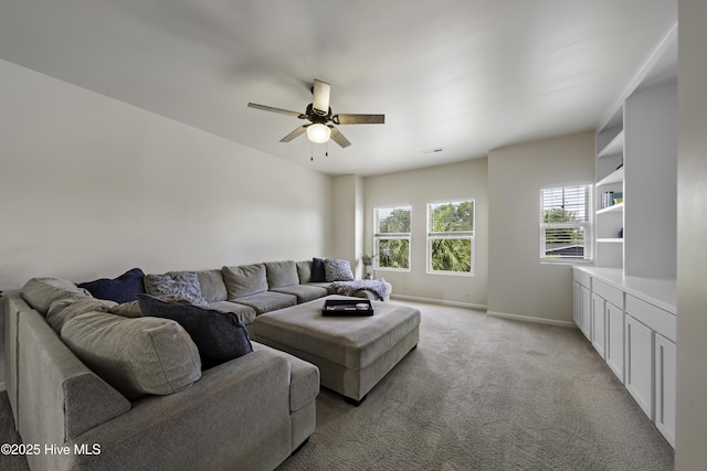 carpeted living room with ceiling fan