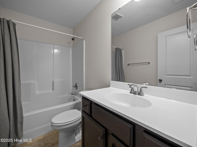 full bathroom featuring vanity, shower / tub combo, tile patterned floors, and toilet