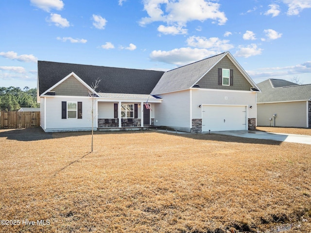 view of front of home featuring a garage and a front yard