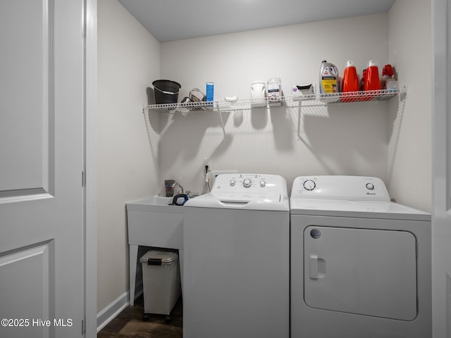 washroom with dark wood-type flooring and independent washer and dryer