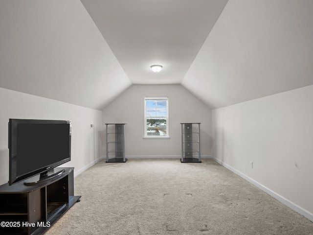 additional living space with vaulted ceiling and light colored carpet