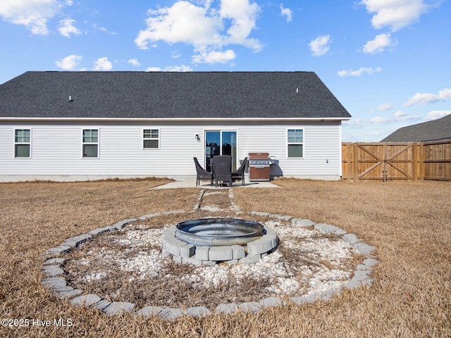 back of property featuring a patio, a jacuzzi, and a fire pit