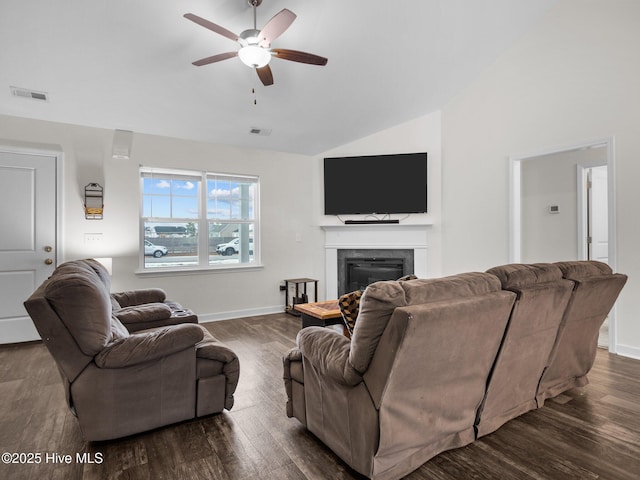 living room with lofted ceiling, dark wood-type flooring, and ceiling fan