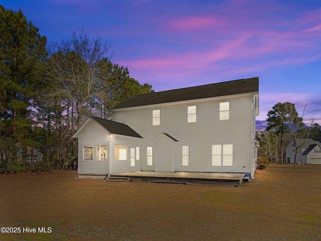 view of back house at dusk