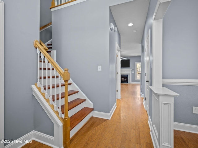 stairs featuring hardwood / wood-style floors