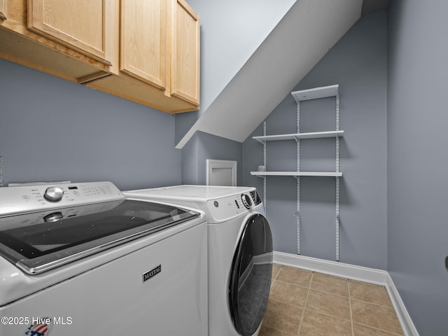 washroom featuring cabinets, light tile patterned flooring, and independent washer and dryer