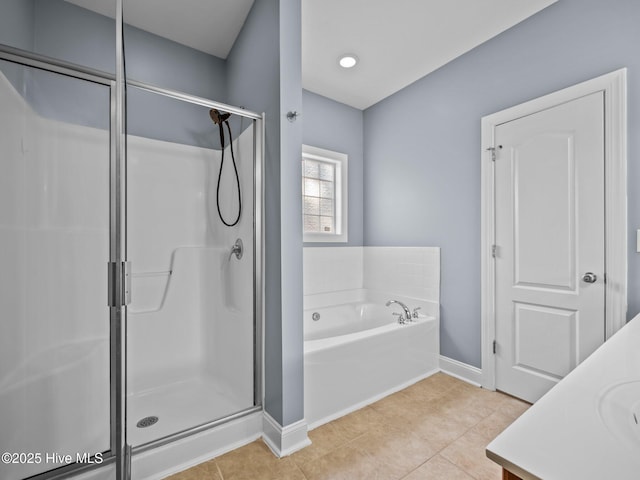 bathroom featuring vanity, plus walk in shower, and tile patterned flooring