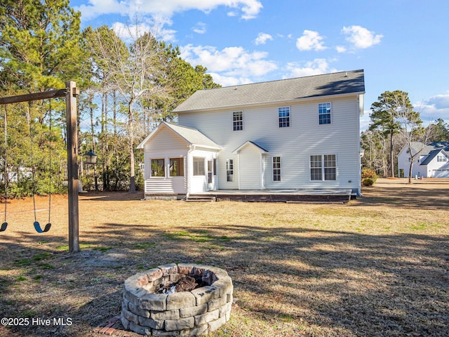 back of house featuring a fire pit