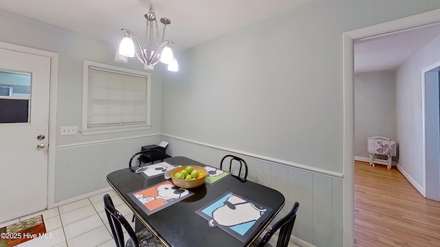 dining room with an inviting chandelier and light wood-type flooring