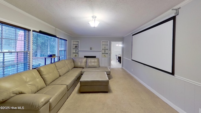 home theater featuring crown molding, built in features, light colored carpet, and a textured ceiling