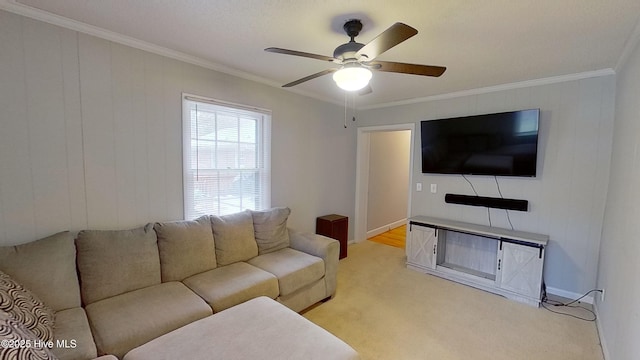 carpeted living room with crown molding and ceiling fan