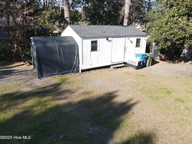 view of outdoor structure with a lawn